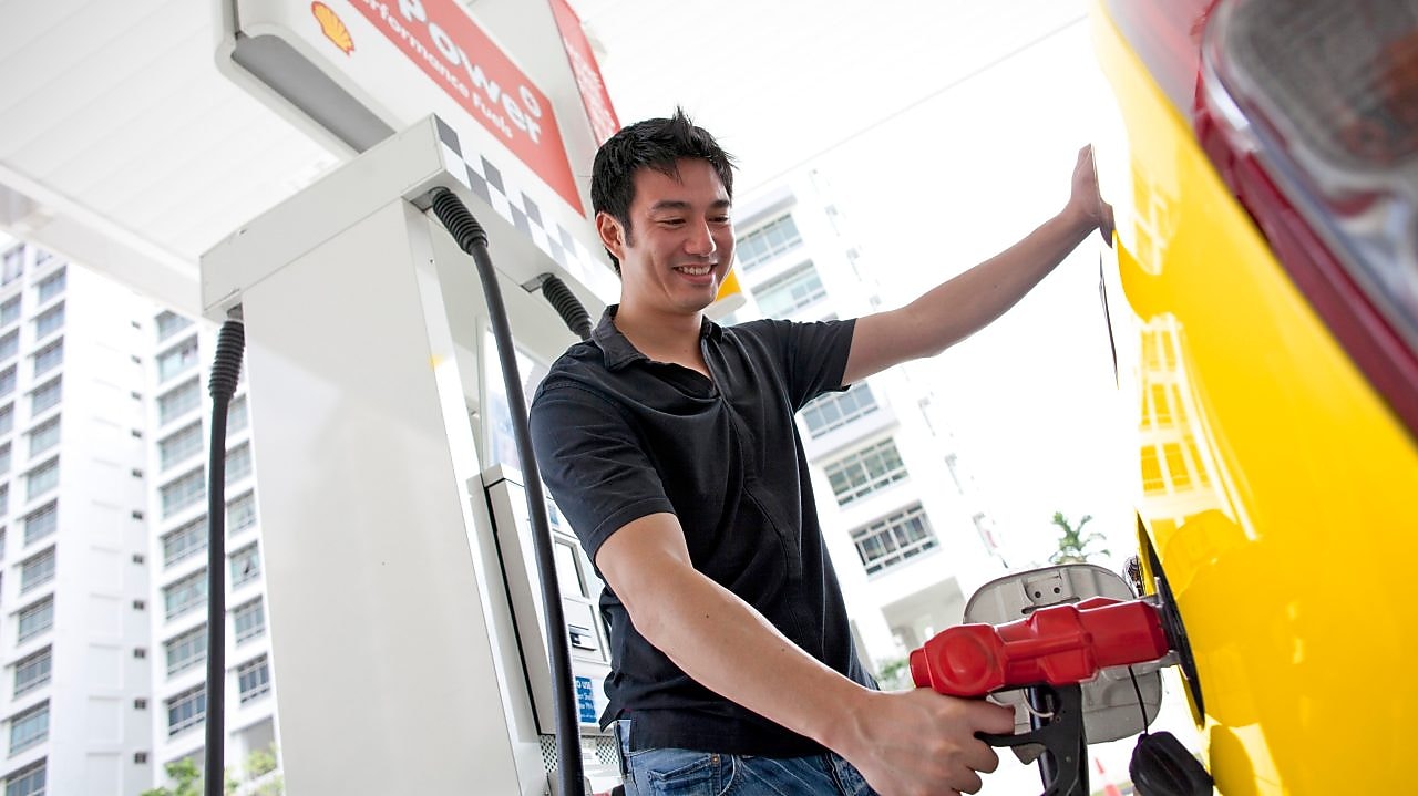 Man refueling his car at a petrol pump