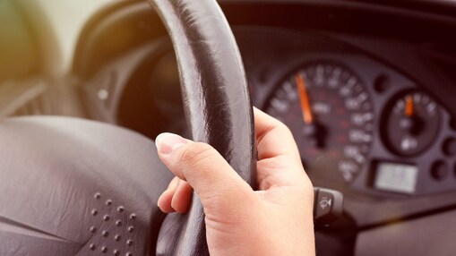 Hand holding a steering wheel