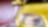 Front of a yellow car driving through a tunnel, right front light and wing mirror in view