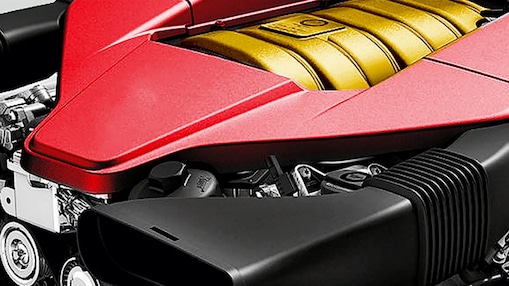 The engine of a car, with red trim and gold middle