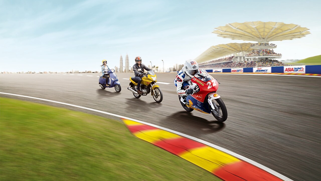 Three different types of motorbike riding round a racing track