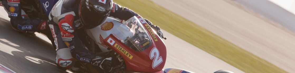 An ATC superbike races around a race track
