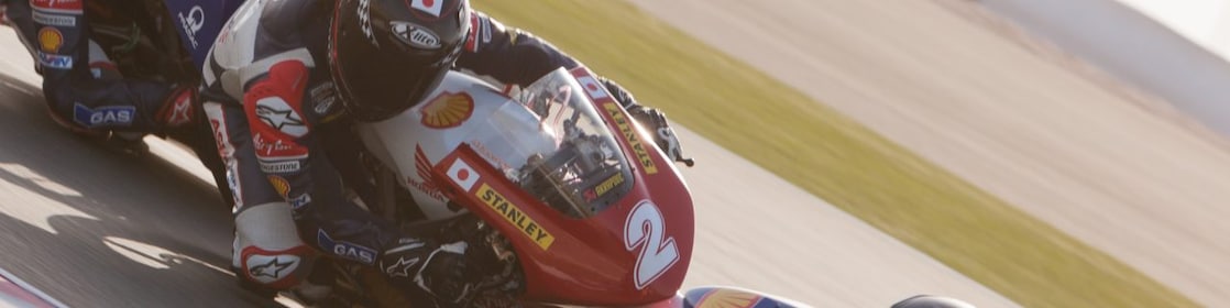An ATC superbike races around a race track