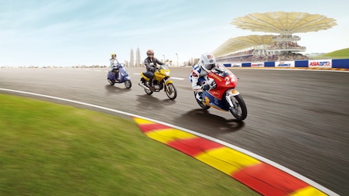 Three different types of motorbike riding round a racing track