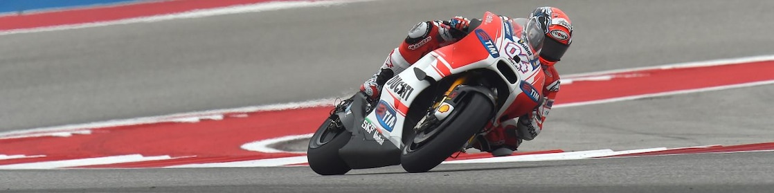 Ducati motorcycle racing around a corner of a racing track