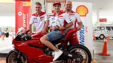 Ducati superbike with seated rider and tech team