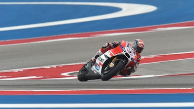 Ducati motorcycle racing around a corner of a racing track