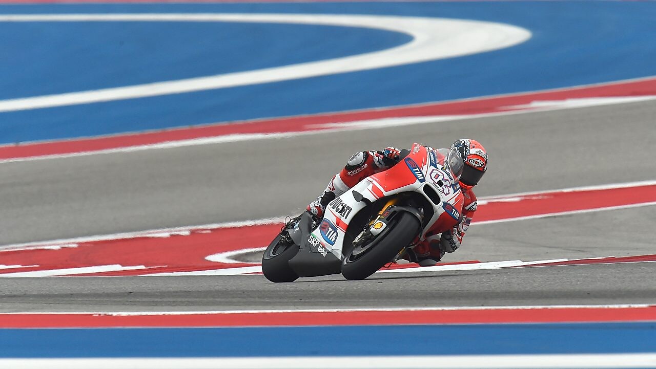Ducati motorcycle racing around a corner of a racing track