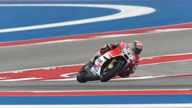Ducati motorcycle racing around a corner of a racing track