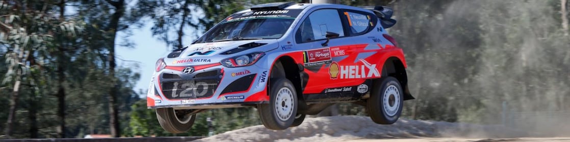 An Hyundai Shell World Rally Team car racing through a forest