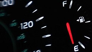 Dashboard display in car showing low fuel