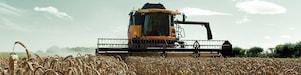 Yellow combine harvester in a wheat field