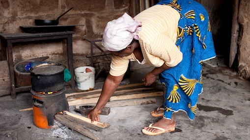 Lady cooking on a cookstove in Nigeria