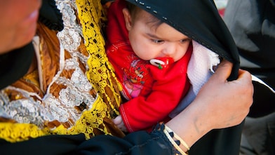 A parent holding their child