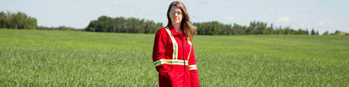 An employee stands in a field near a Quest C02 injection well northeast of Edmonton, Alberta in Canada